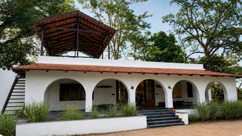 A lodge with an arched veranda and elevated viewing deck